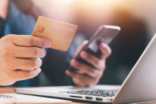 Person with credit card and smartphone shopping online, DA, close-up, modern shopping and financial technology, digital payment, Munich, credit card, laptop, everyday life, technology, innovation.