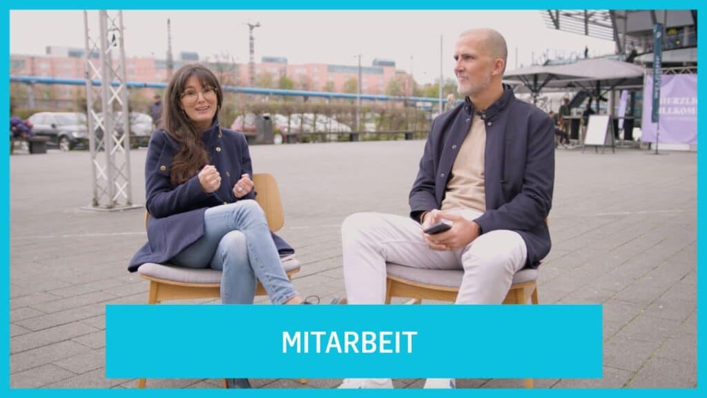 Two people in conversation outdoors, at ICF Munich, experience community and collaboration in a modern worship and meet-up environment.